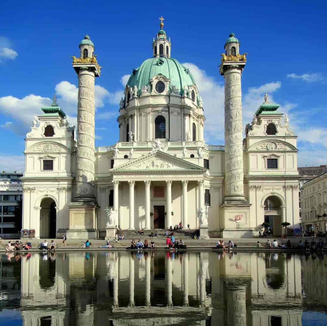 St. Charles Church in Vienna mirroring in water on a bright day