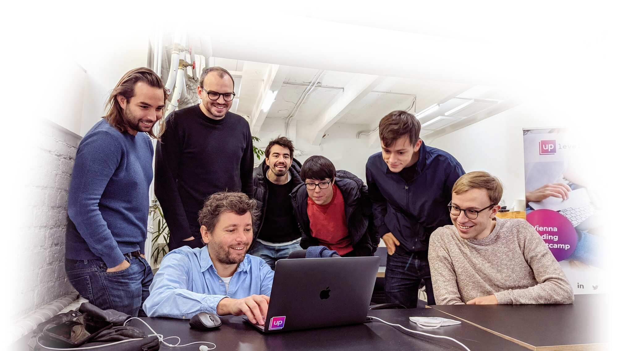 An UpLeveled teacher guides participants through a practical exercise at a laptop